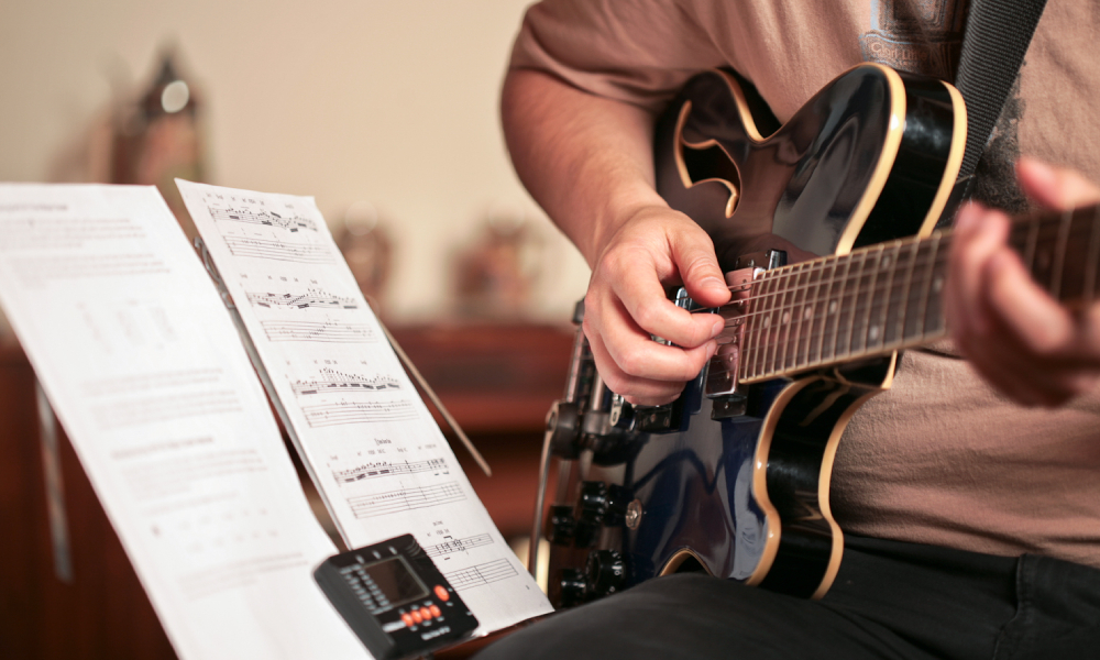 Image Representing A Boy Playing Musical Instrument - Guitar.